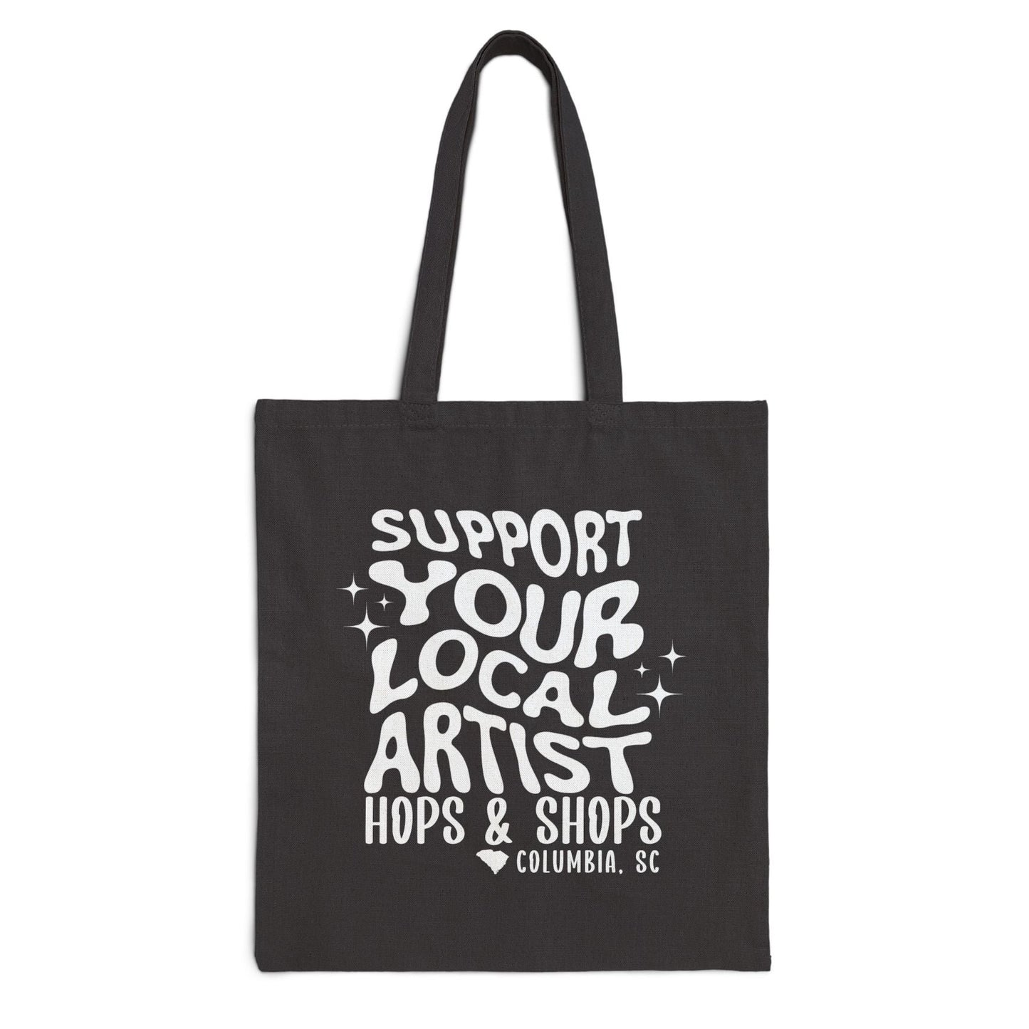 Black tote bag with white text 'Support Your Local Artist Hops & Shops Columbia, SC' on a white background