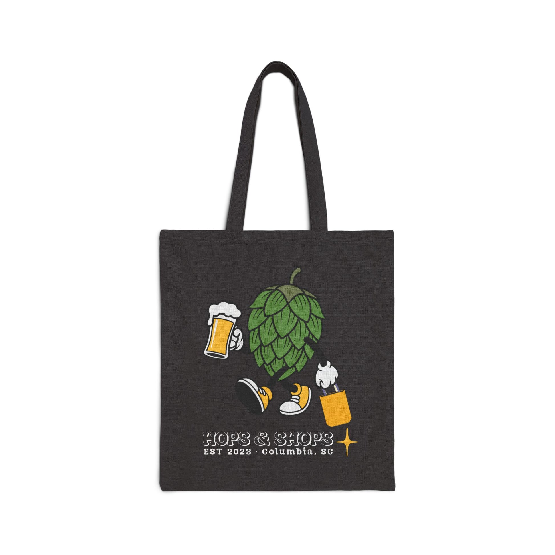 Black tote bag with beer-themed design and 'HOPS & SHOPS' branding on a white background